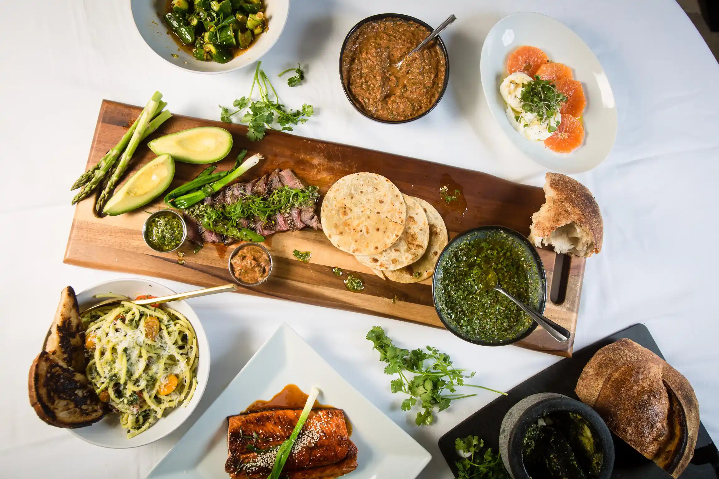 Private chef-prepared steak, flatbreads, salmon, and fresh side dishes